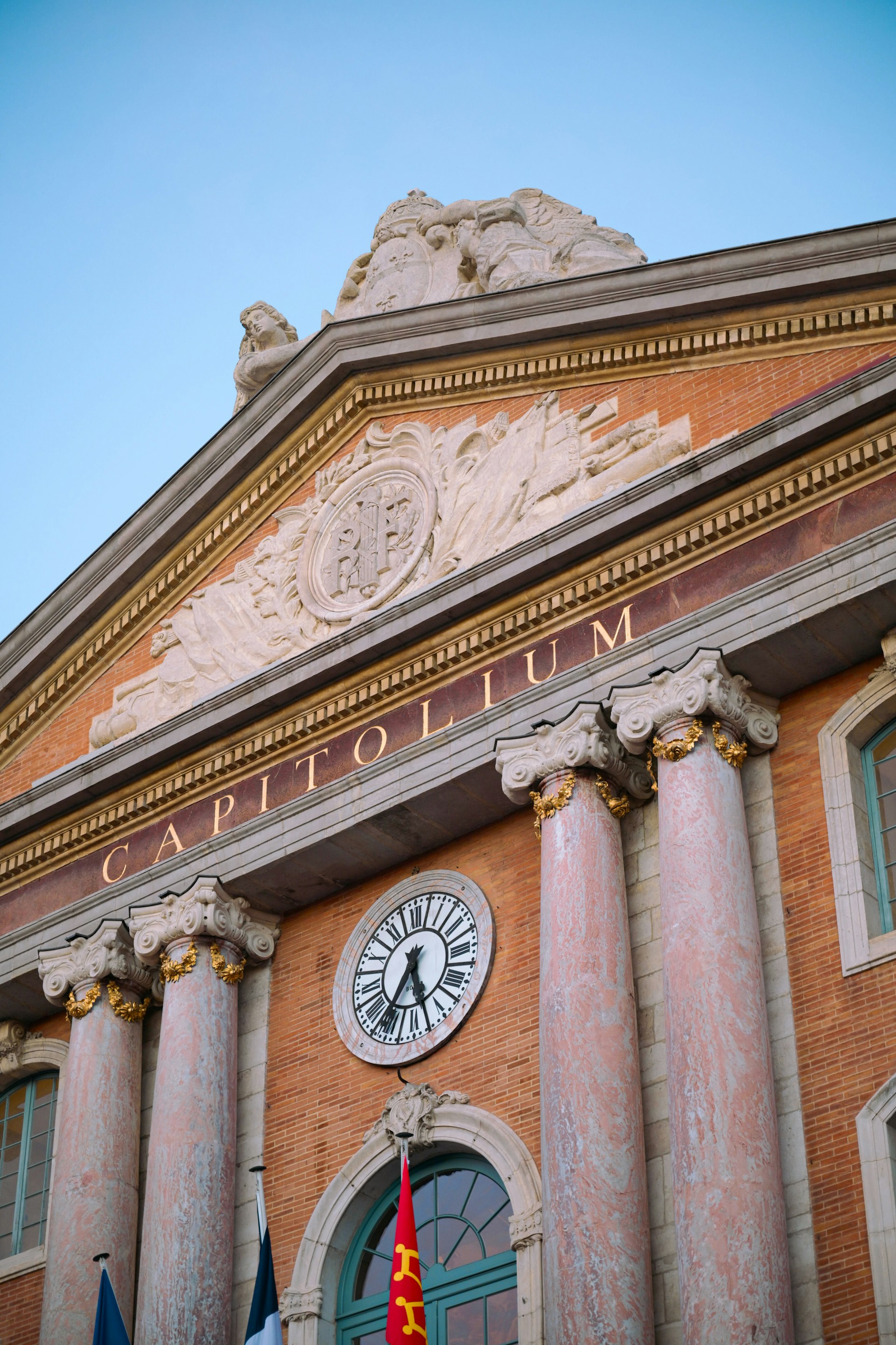 Classical building facade with clock and columns