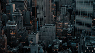 Dense cityscape with tall buildings at dusk.