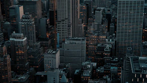Dense cityscape with tall buildings at dusk.