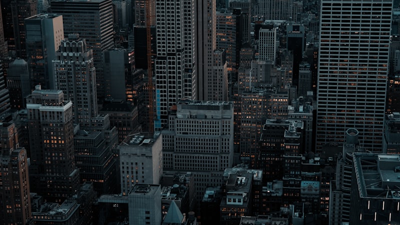Dense cityscape with tall buildings at dusk.