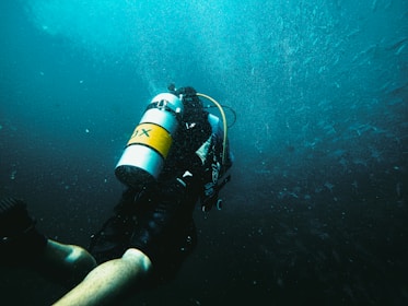 Scuba diver exploring dark blue ocean depths