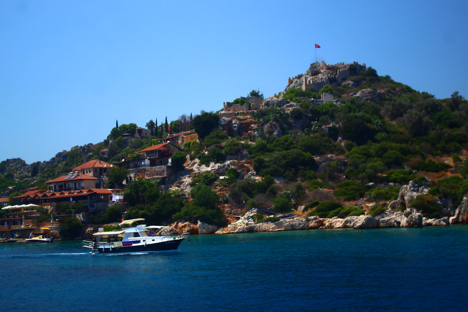 Boat passing Kaleköy (Simena) and its castle at Kekova