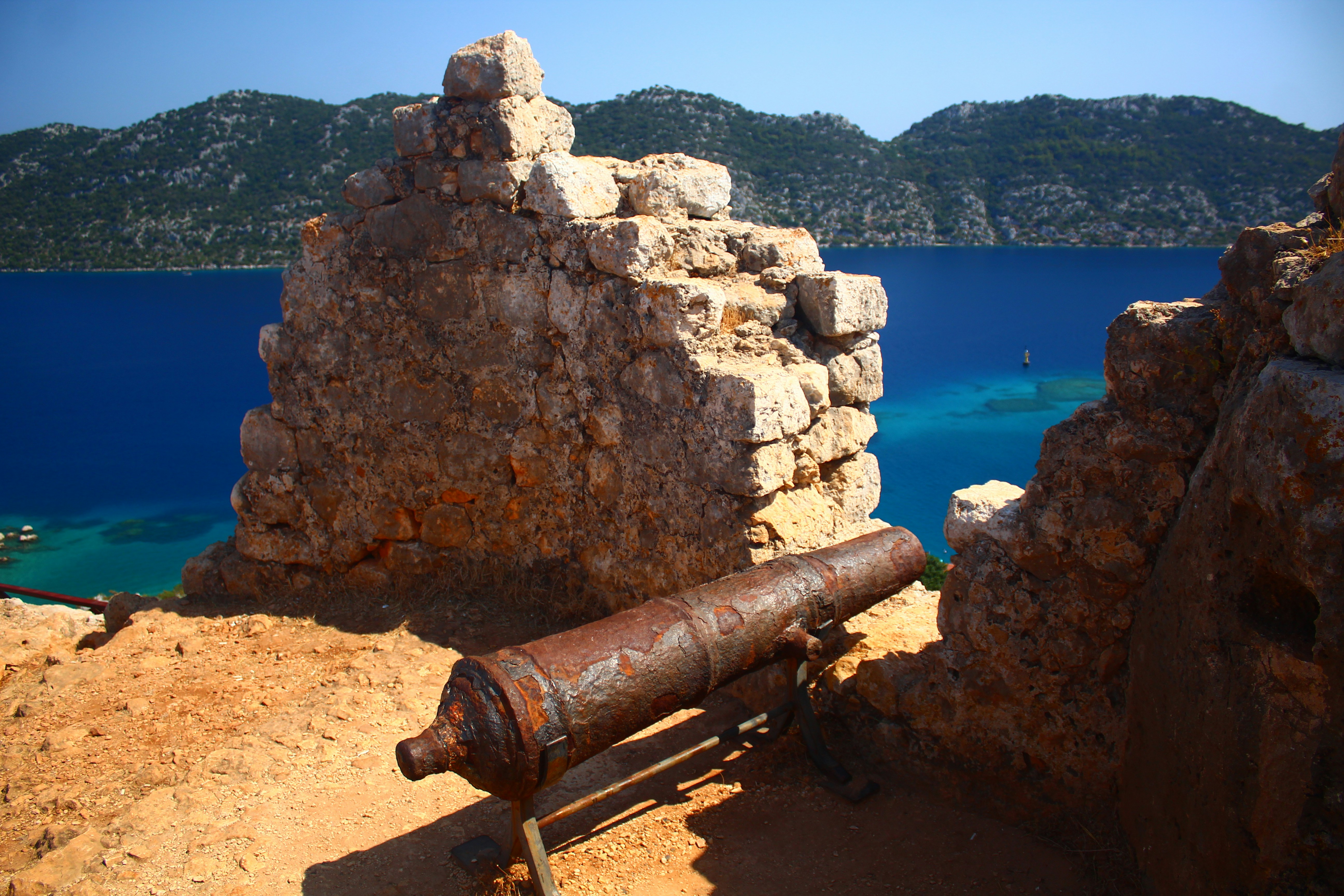 Old cannon on a stone wall overlooking the sea