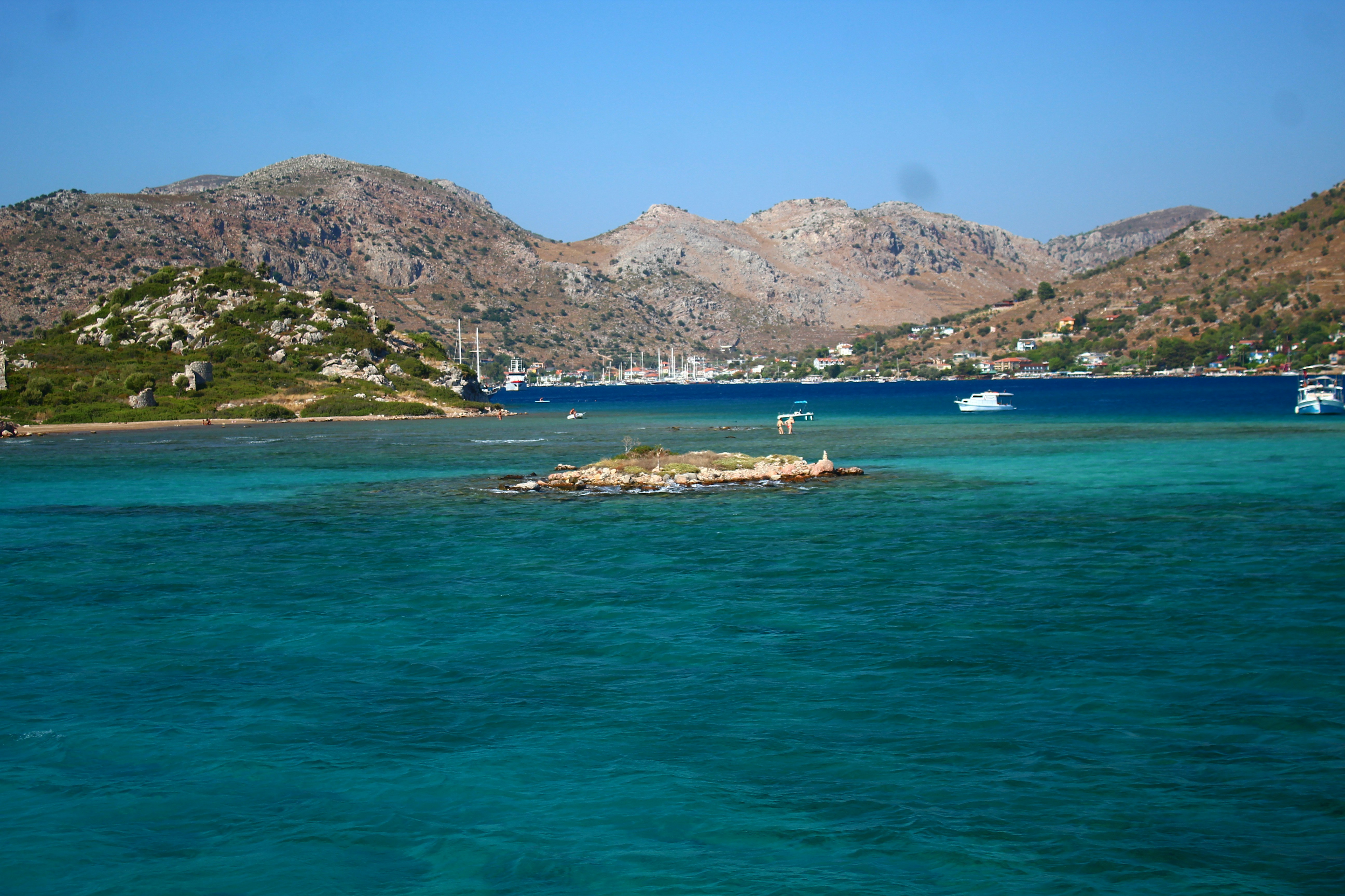 Sailing boats on turquoise Aegean water near the Bodrum coastline