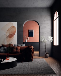 Modern living room with arched doorway and abstract art.