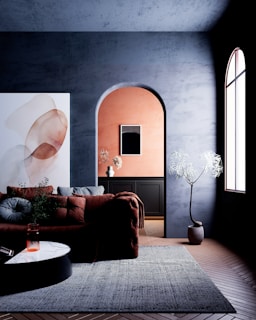 Modern living room with abstract art and archway.