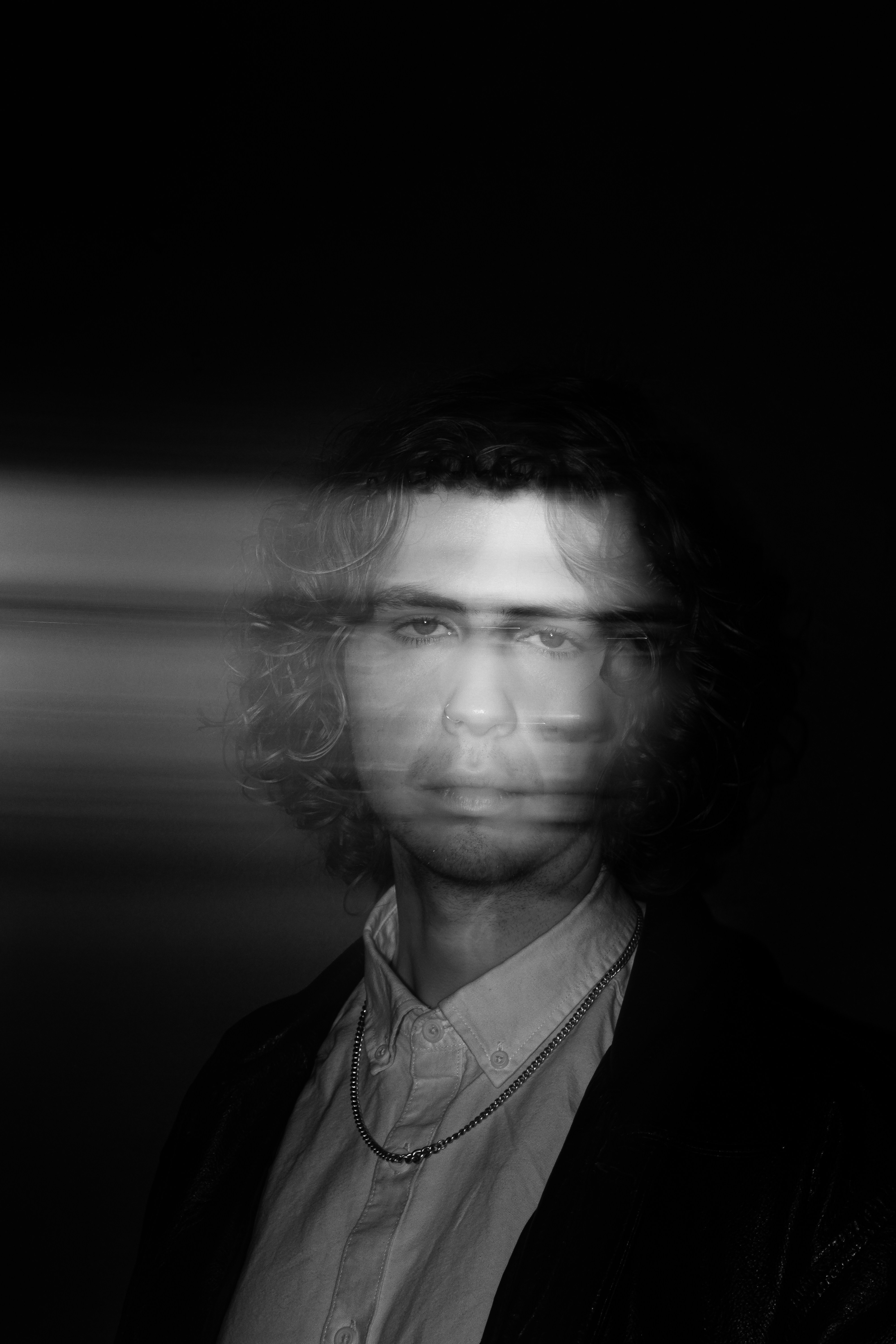 Man with blurred face and light streaks