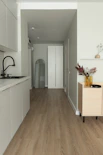 Modern hallway with kitchen and wooden floor