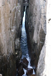 Narrow sea channel between tall rocky cliffs