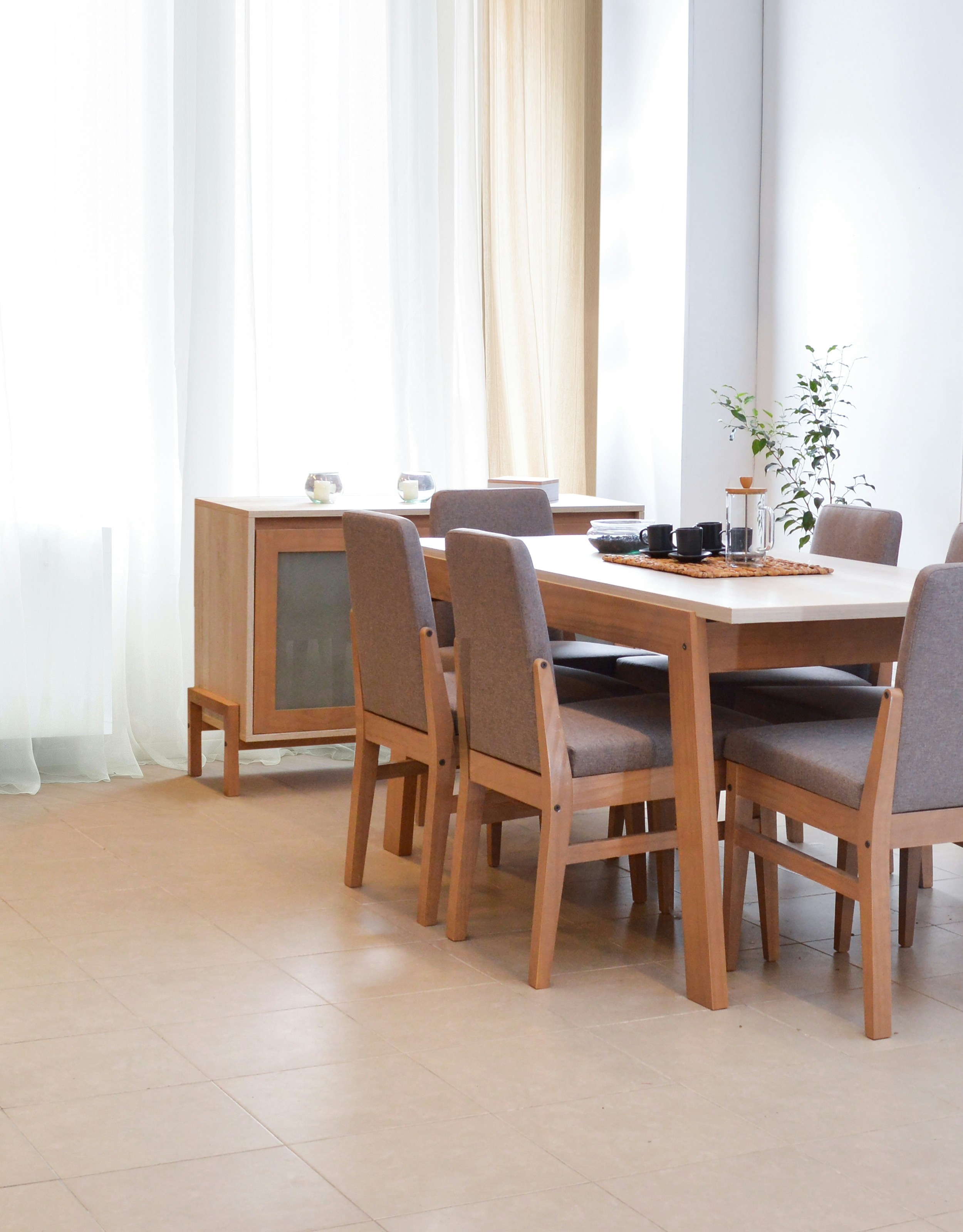 Dining table with chairs in a bright, modern room.