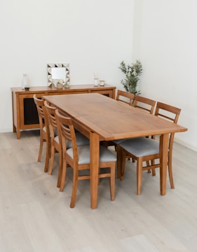 Wooden dining table with chairs and sideboard