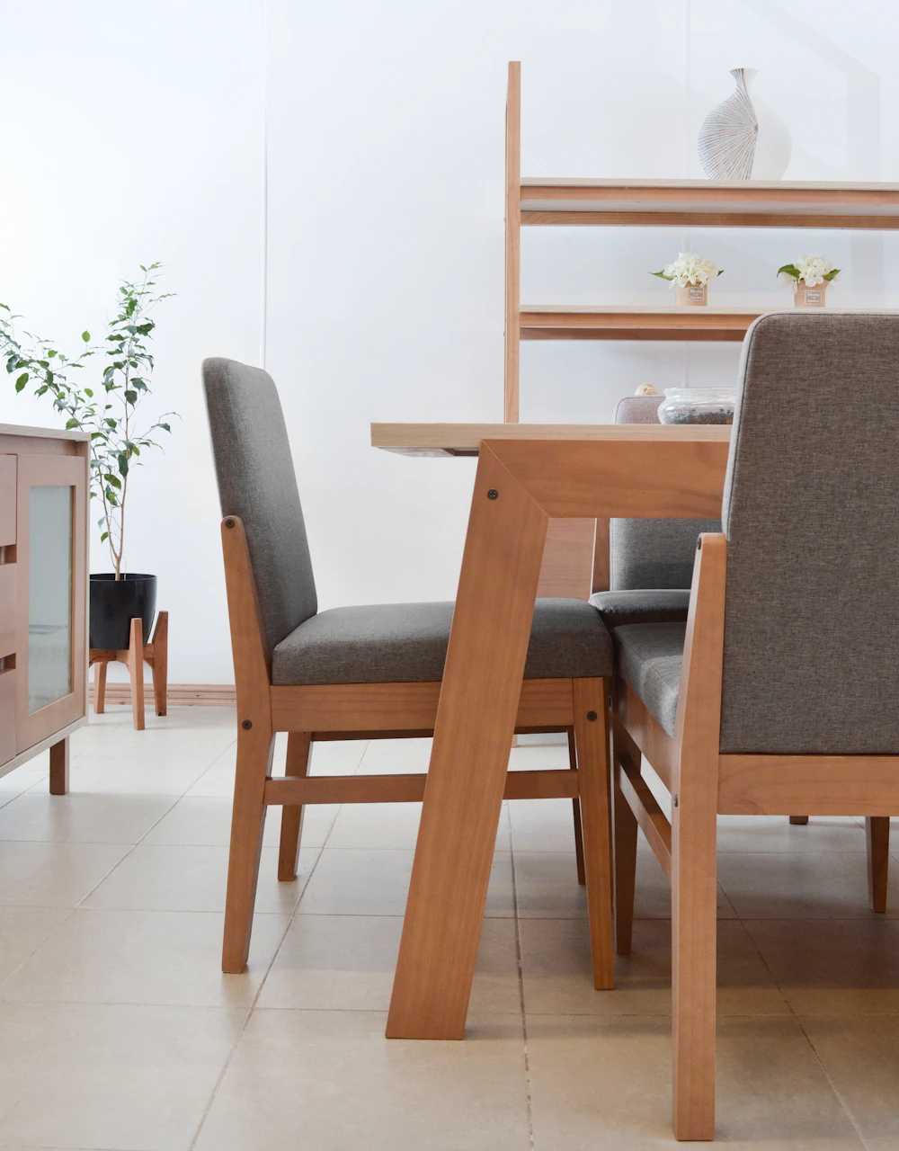 Contemporary dining room furnished with a wooden table, chairs, and warm interior details