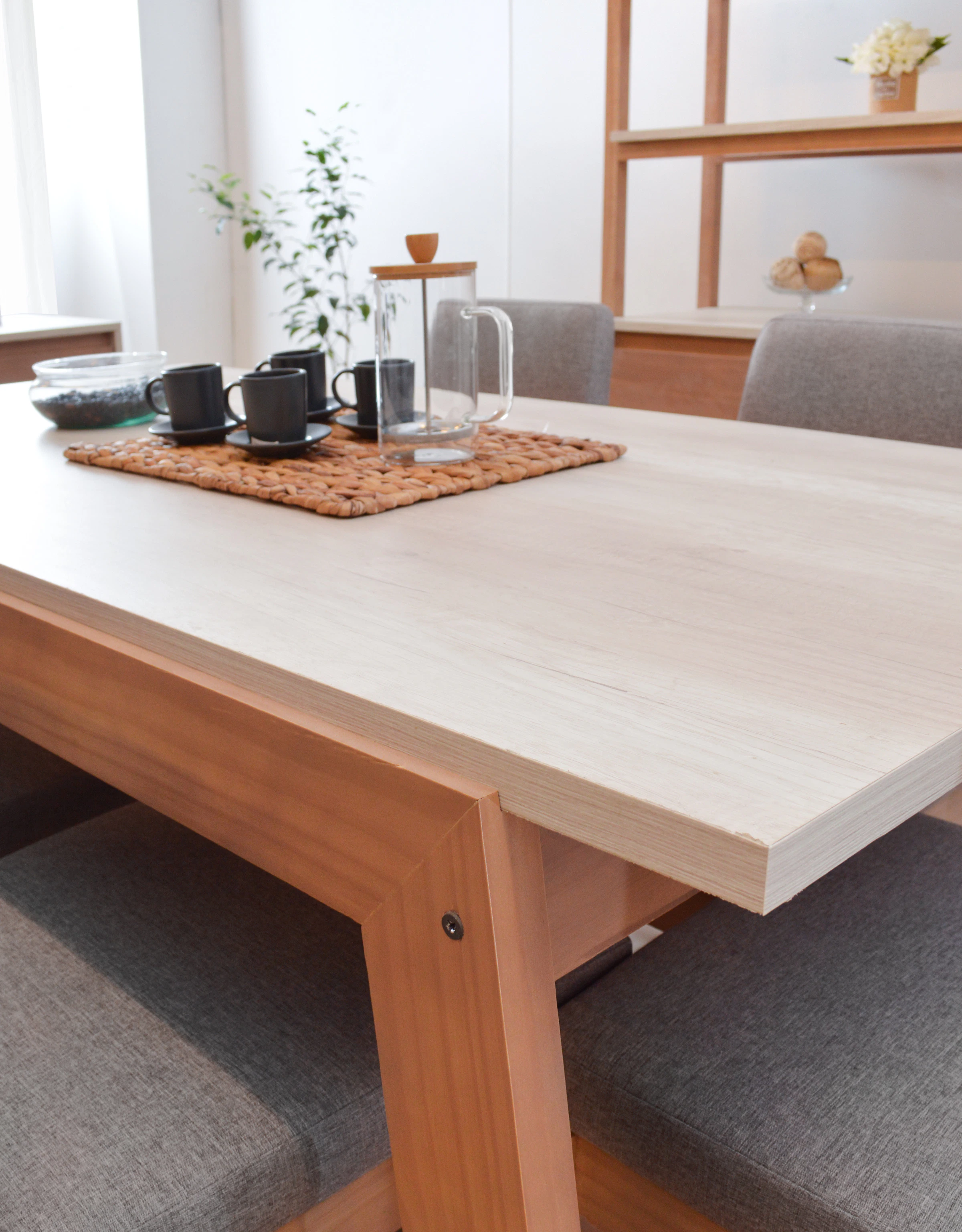 Coffee cups and French press arranged on a refined dining table