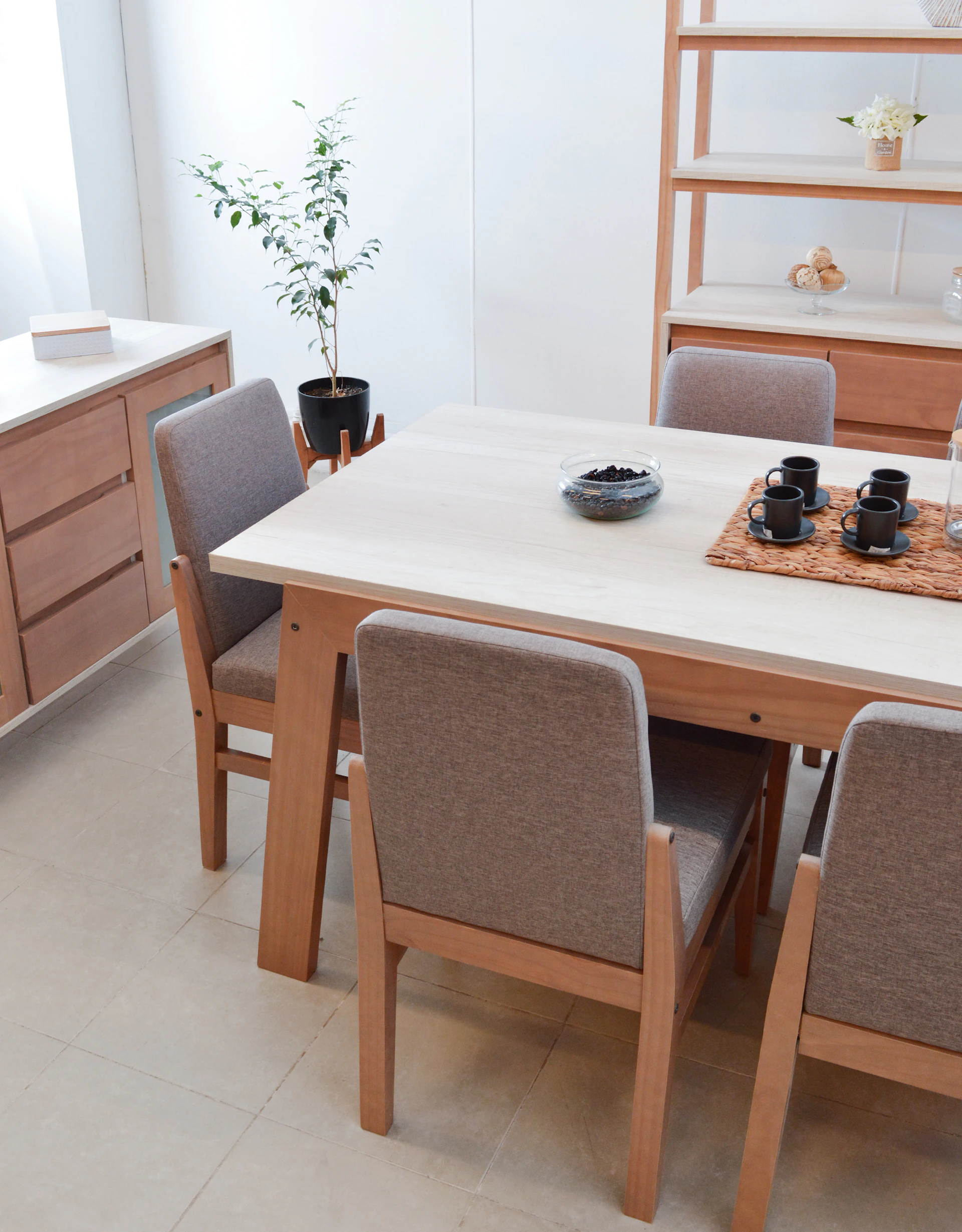 Dining table with chairs and a plant.