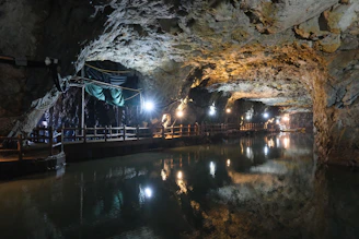 Underground lake in a lit cave, similar to Craighead Caverns at The Lost Sea Adventure