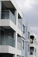 Modern apartment building with balconies and windows.
