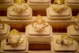 Rows of ornate gold rings displayed on stands.