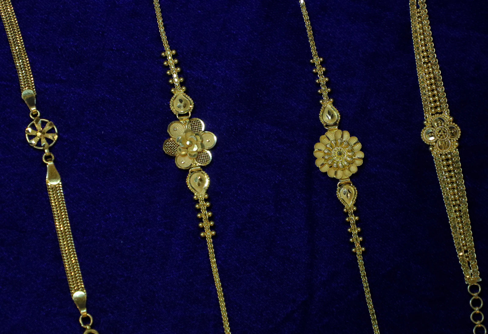 Gold bracelets laid out on velvet