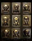 Collection of gold necklaces displayed in a store.