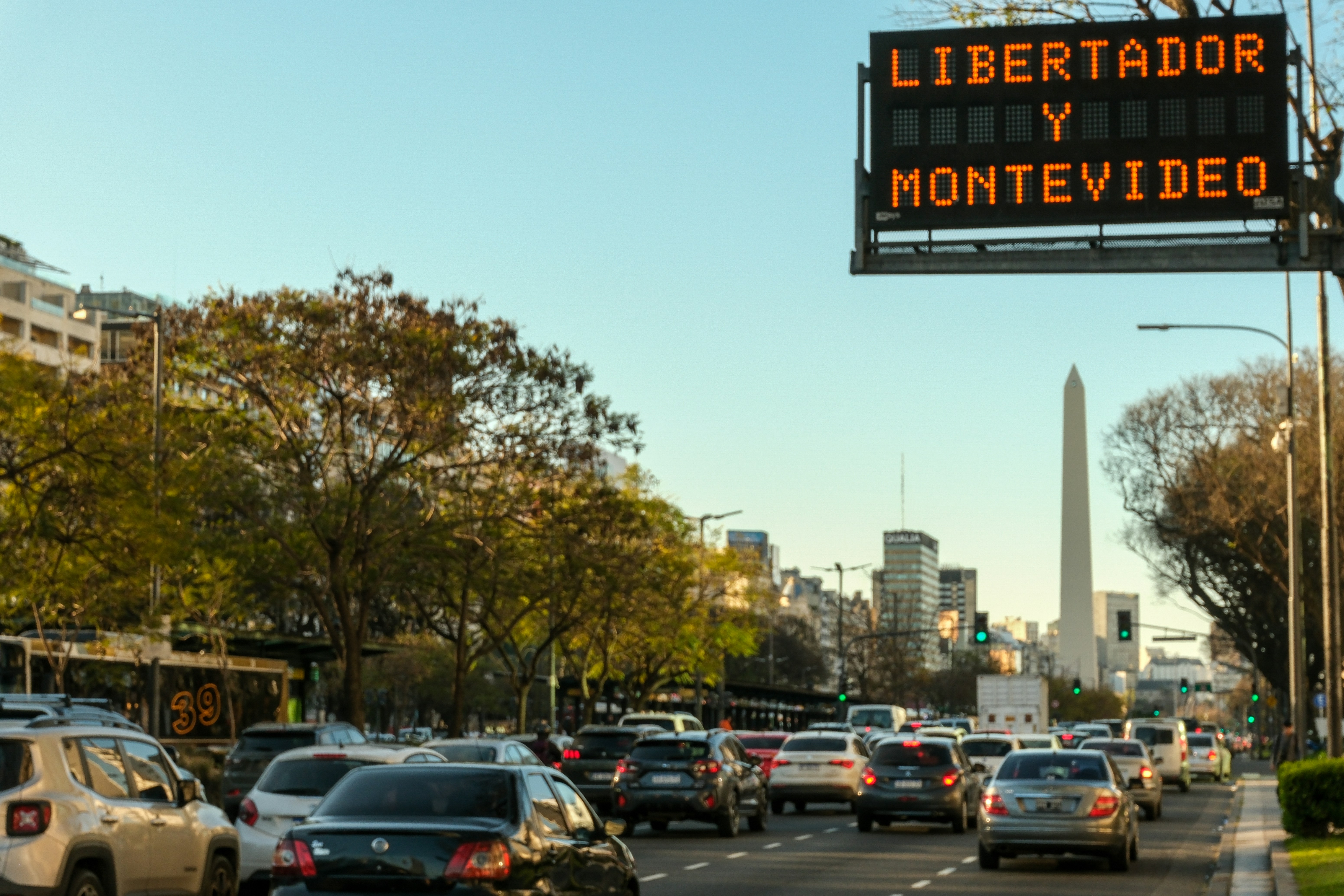Traffic jam on a city street with a digital sign