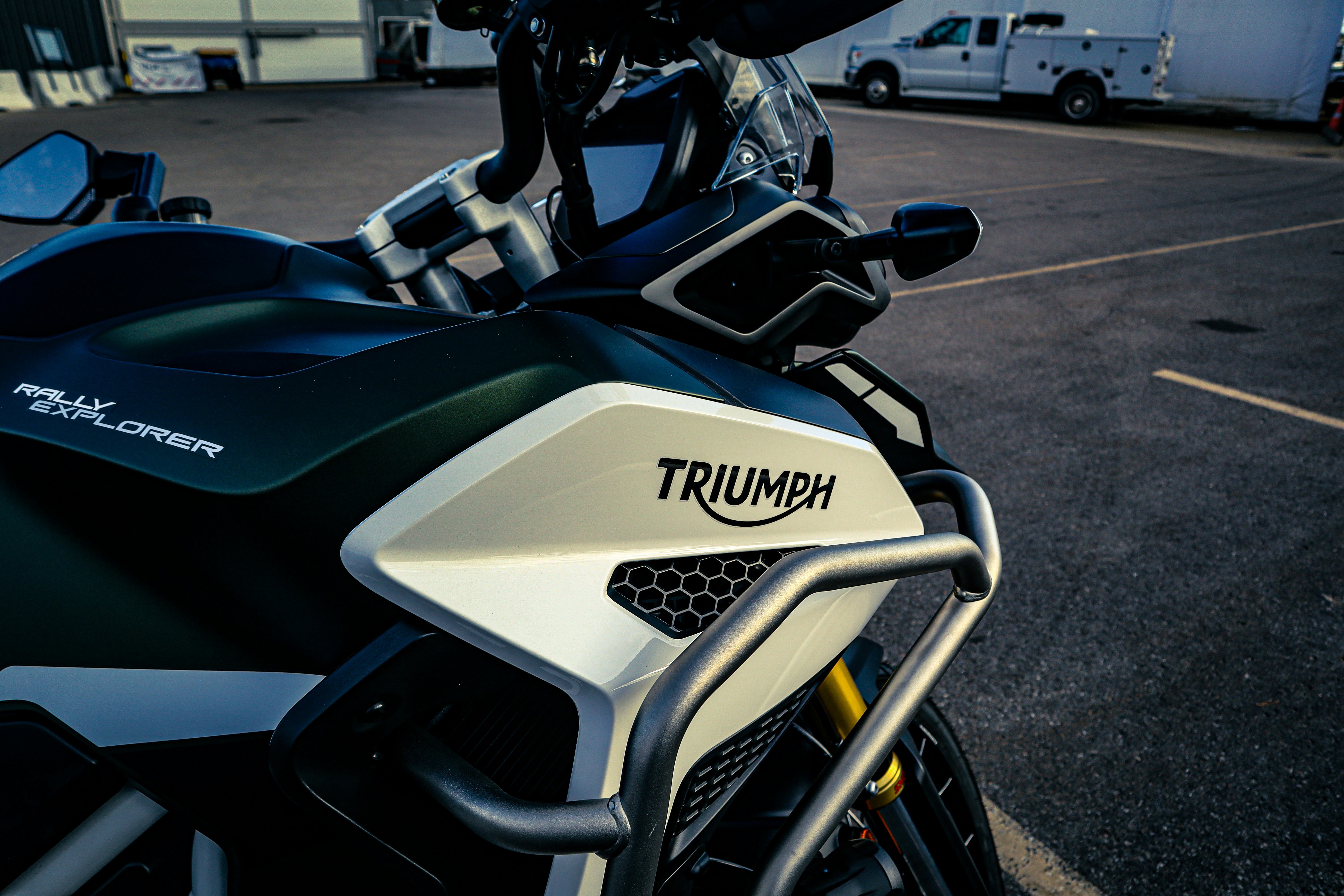 Close-up of a dark green triumph motorcycle.