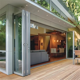 Modern home with folding glass doors opening to deck.