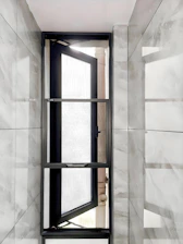 Open modern window with marble tiled walls
