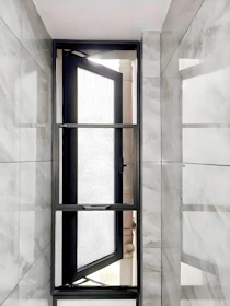Open modern window with marble tiled walls