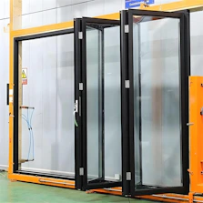 Modern black framed folding glass doors installed