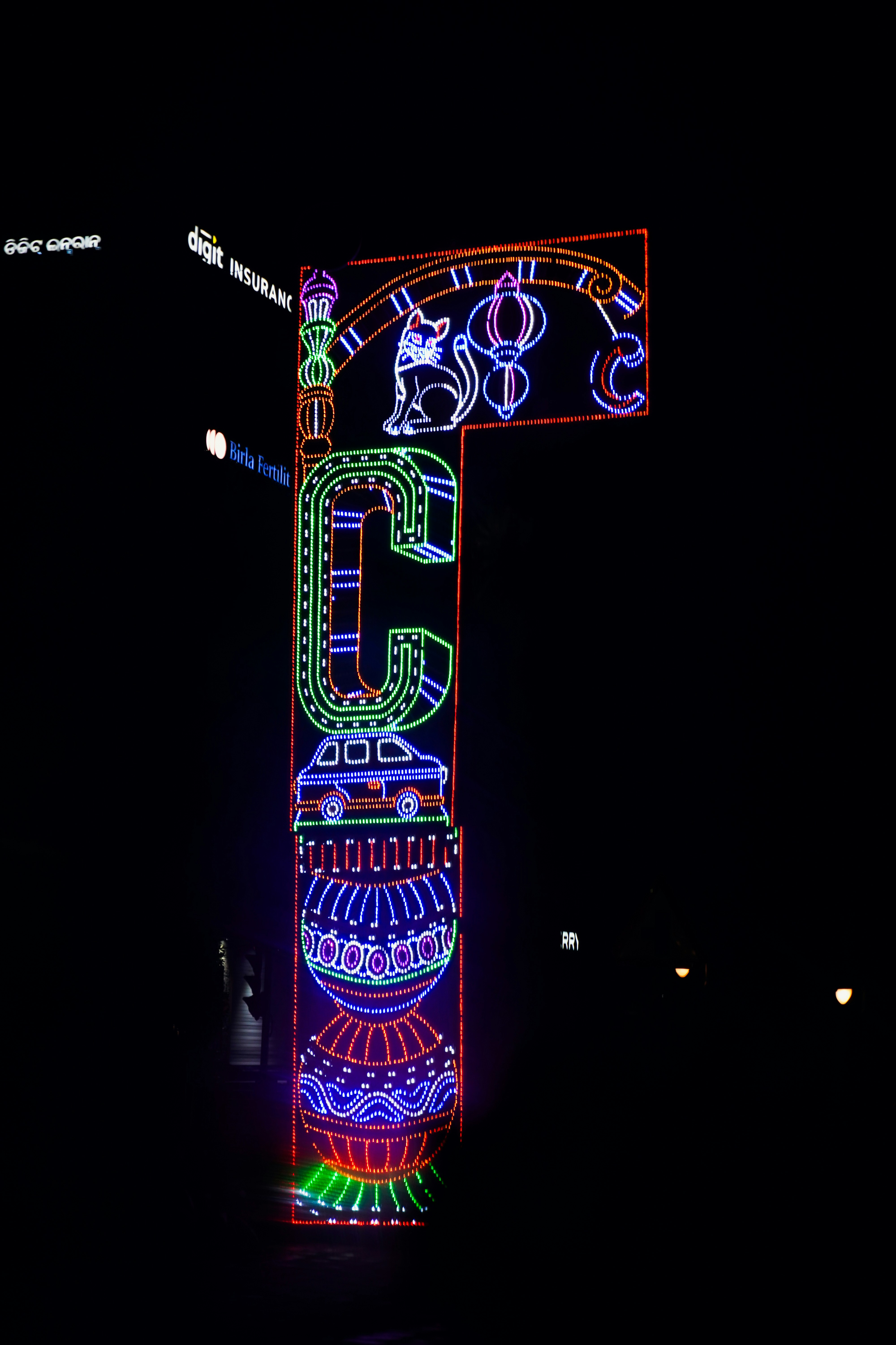 Ornate street lamp decorated with colorful lights at night