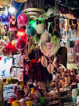Colorful handmade crafts and lanterns displayed at market.