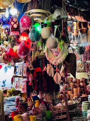 Colorful handmade crafts and lanterns displayed at market.