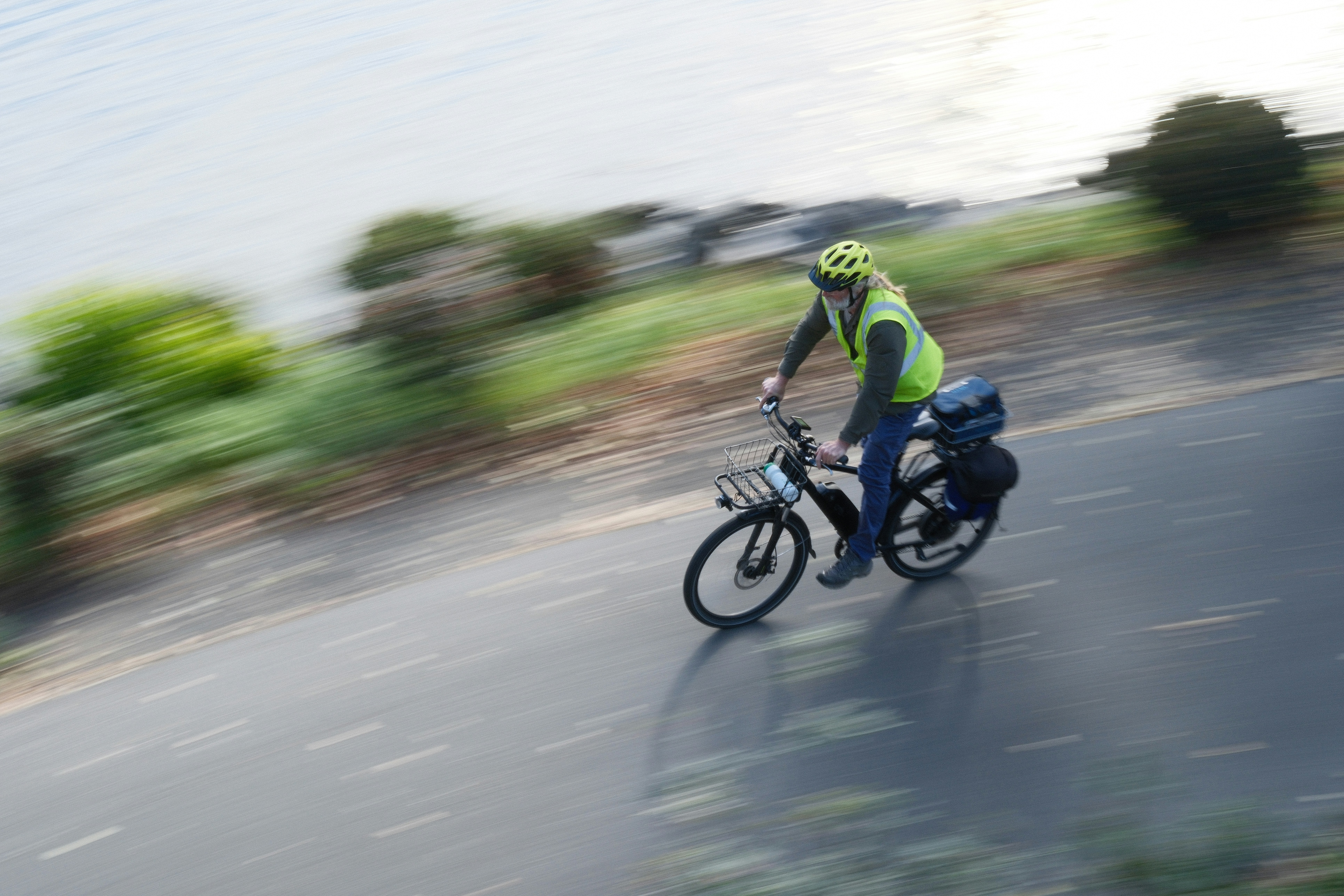 Person cycling on a path next to water