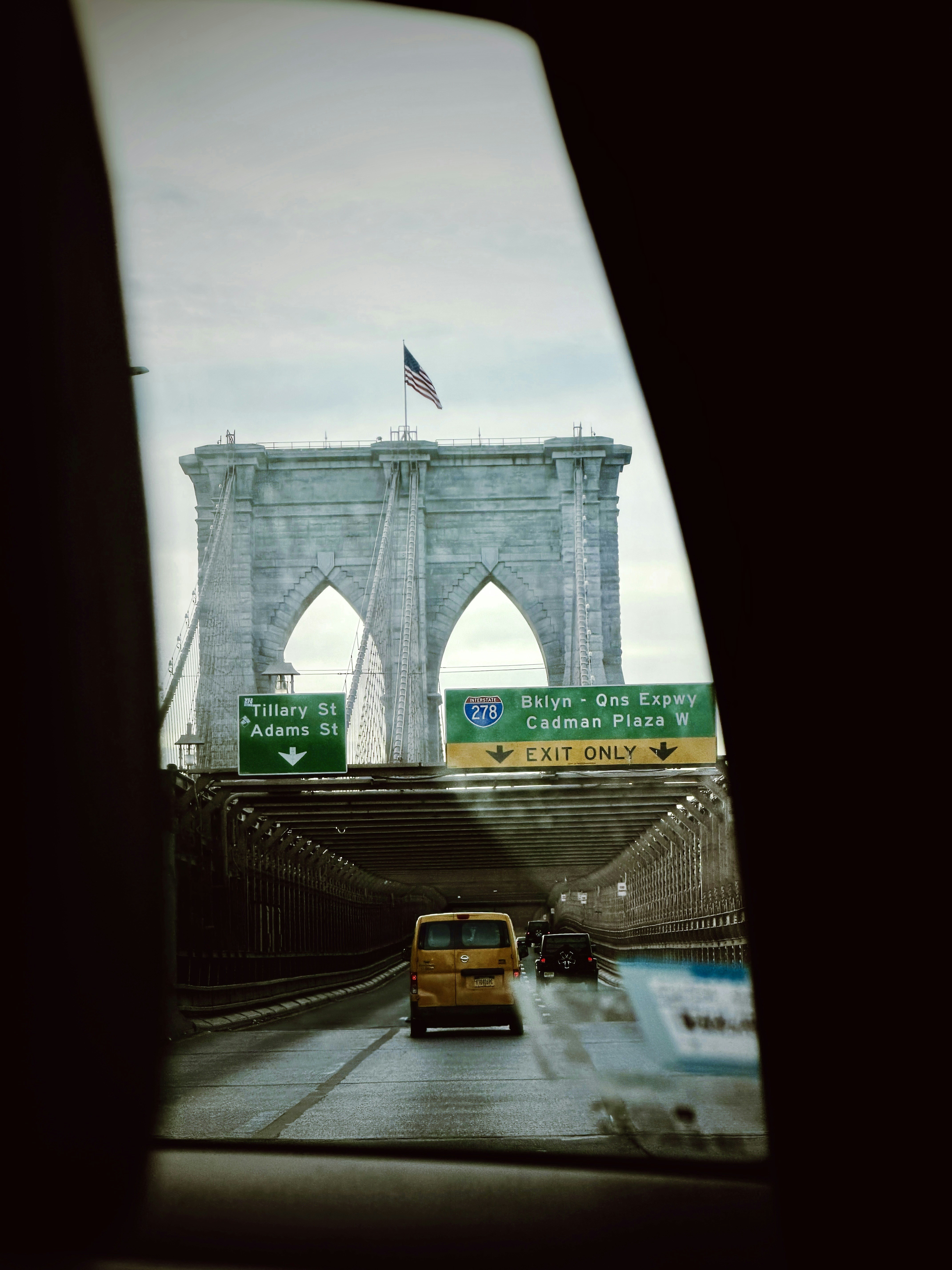 Brooklyn bridge with traffic on a cloudy day