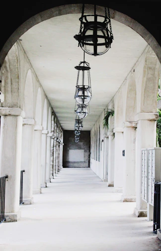 Long arched walkway with hanging lanterns and columns