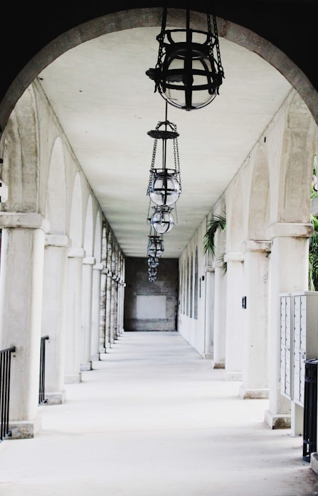 Long arched walkway with hanging lanterns and columns