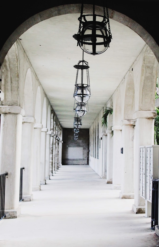 Long arched walkway with hanging lanterns and columns