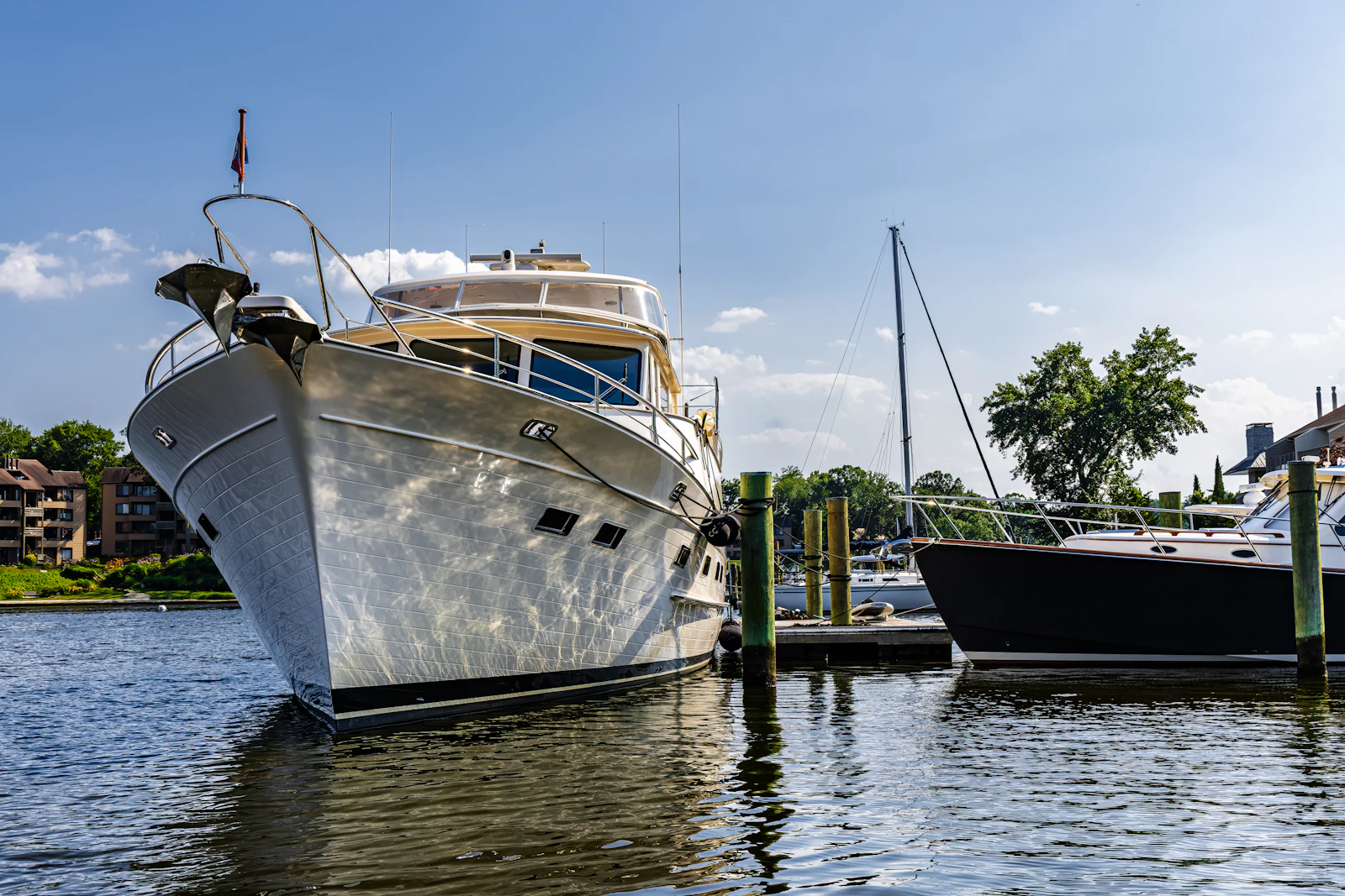 Motor yacht docked at a marina in natural daylight