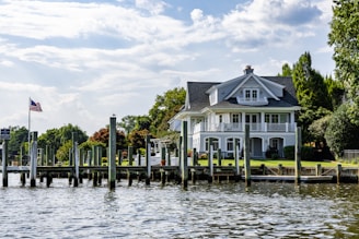 A large house with a dock on the water.