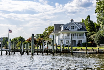 A large house with a dock on the water.