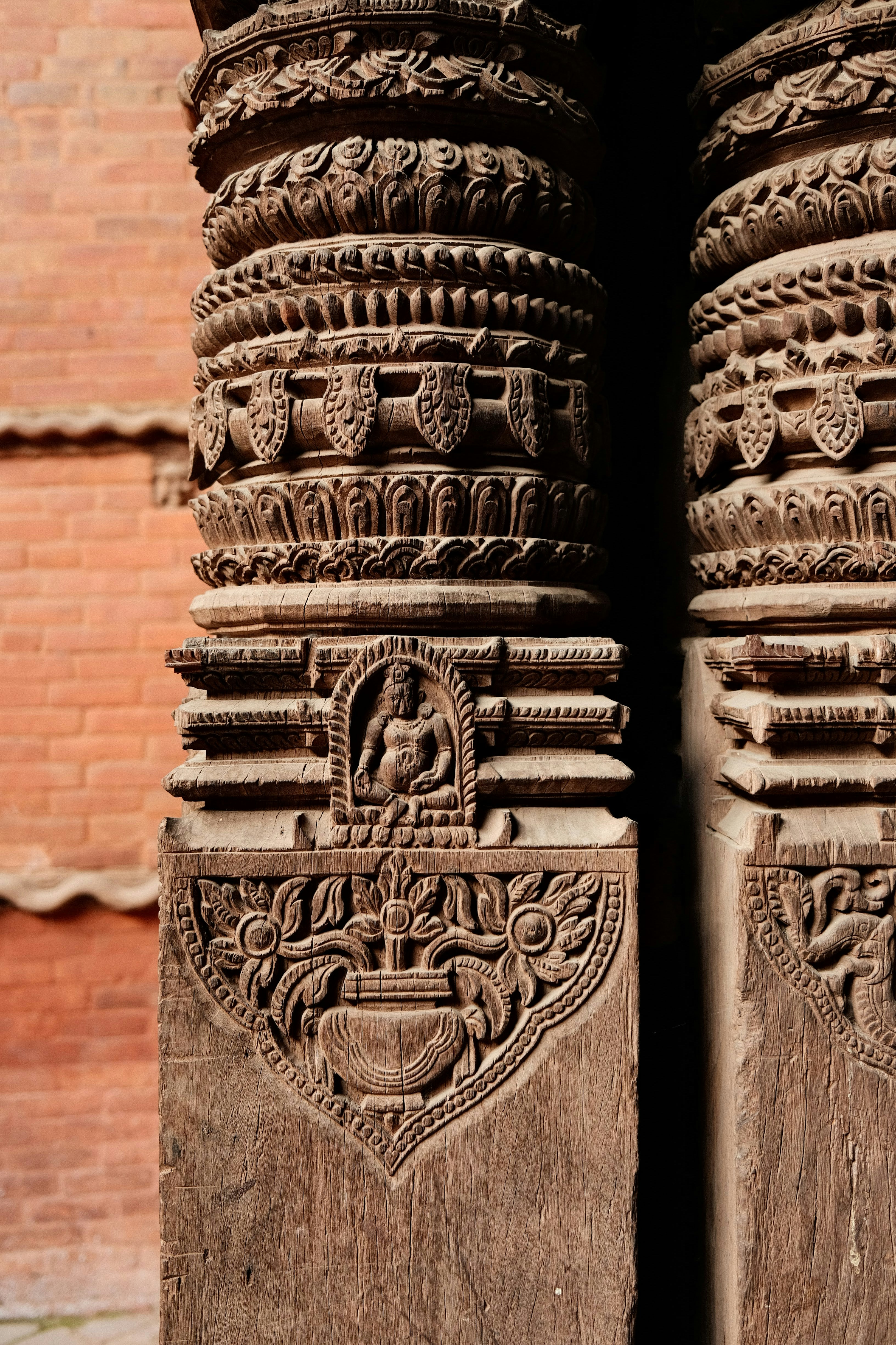 Intricately carved wooden pillars with ancient designs.