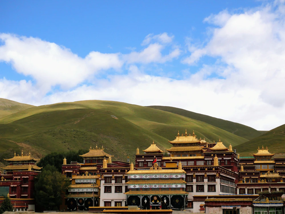 Lithang Monastery and green hills in Litang, Garzê