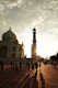 Taj mahal at sunset with people walking