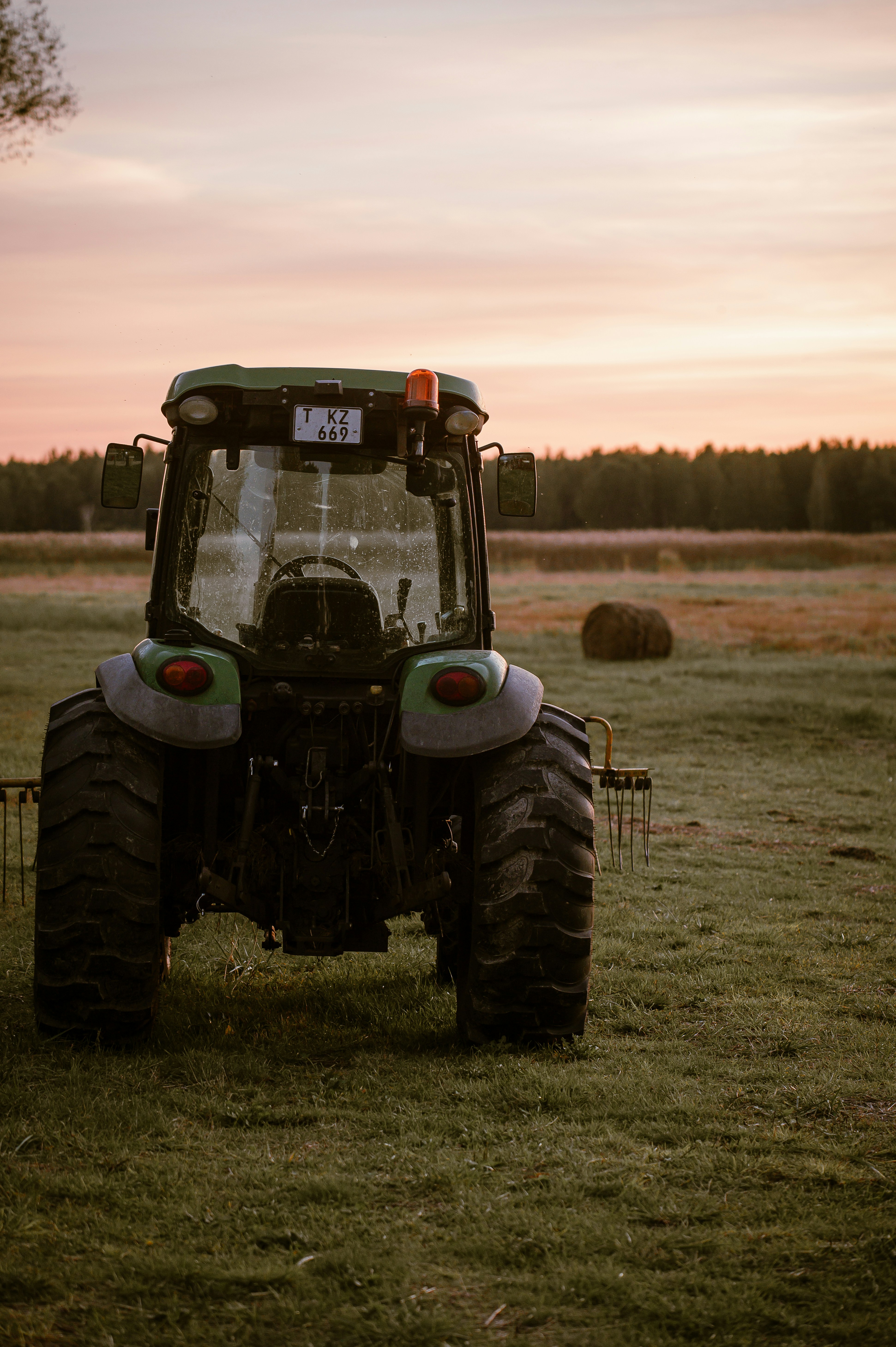 Tractor in a field at sunset