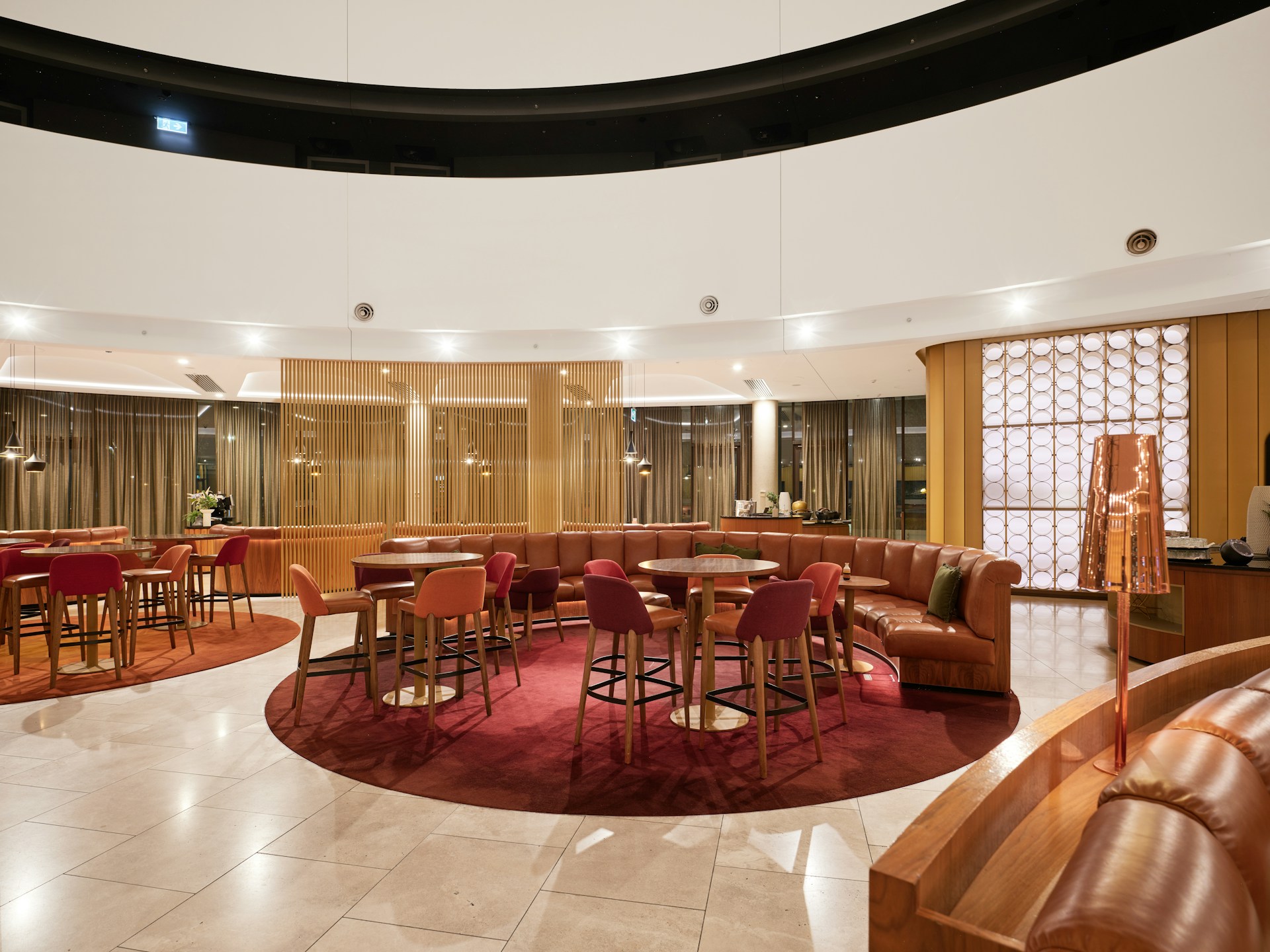 Circular lounge area with modern seating and warm lighting.