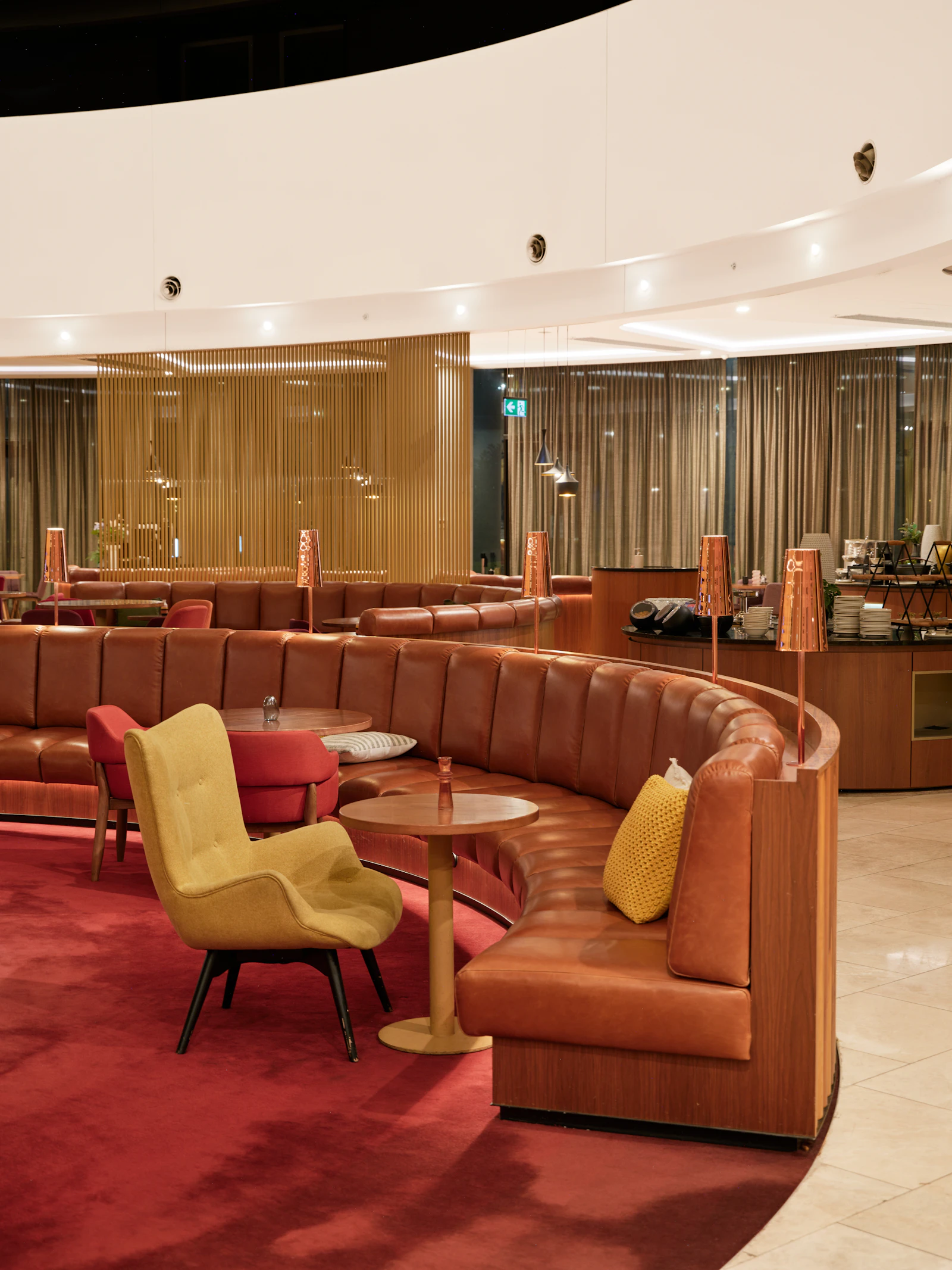 Curved leather booths in a softly lit private lounge