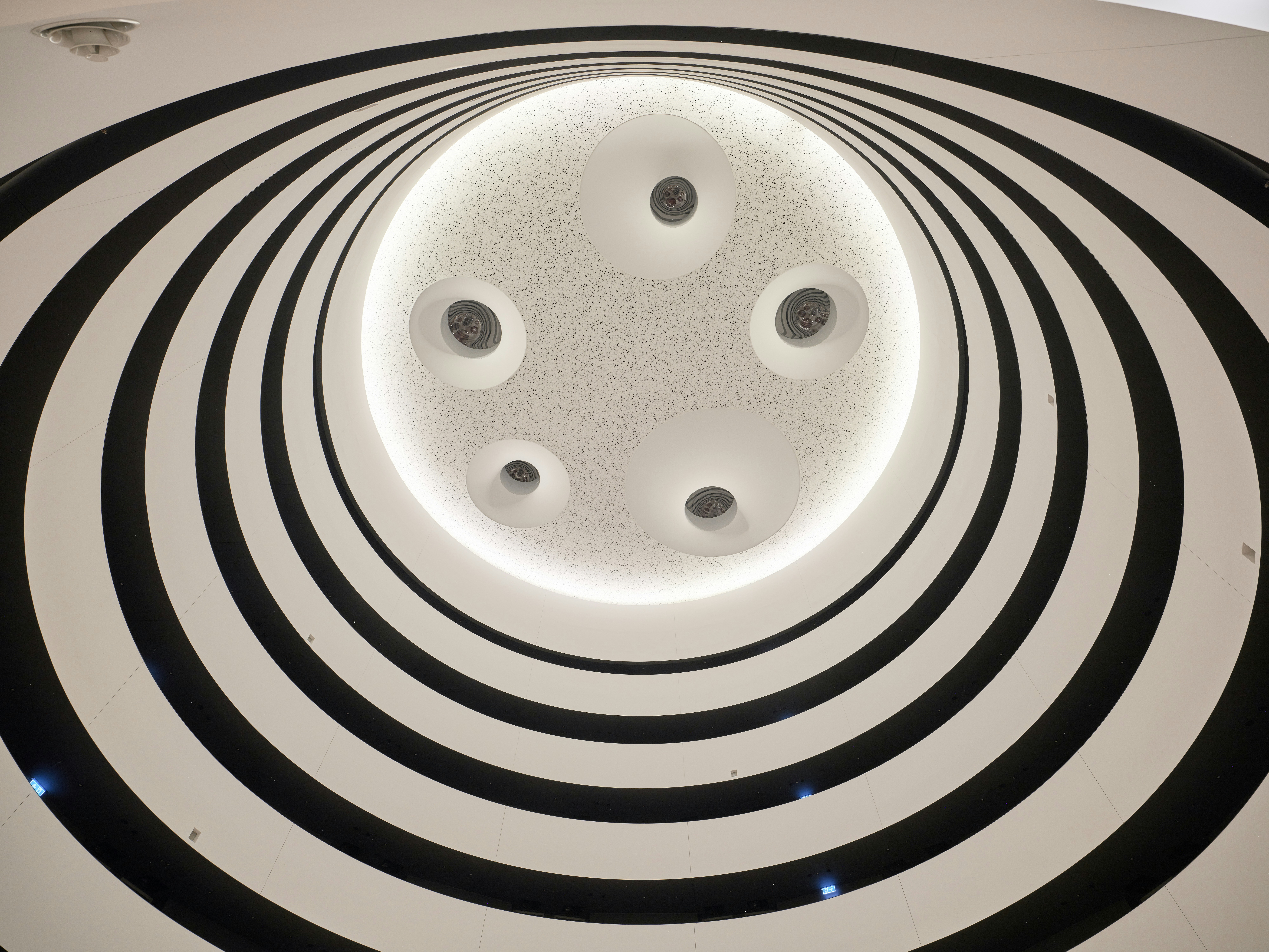 Abstract view looking up through black and white concentric circles