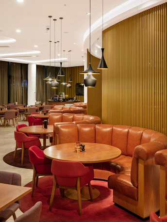 Modern restaurant interior with booth seating and tables