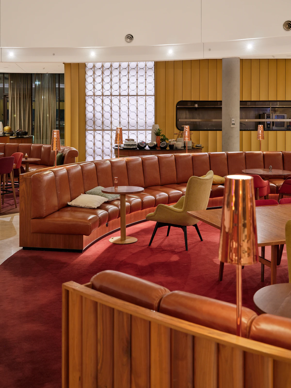 Lounge with curved leather seating and warm lighting (stock placeholder)