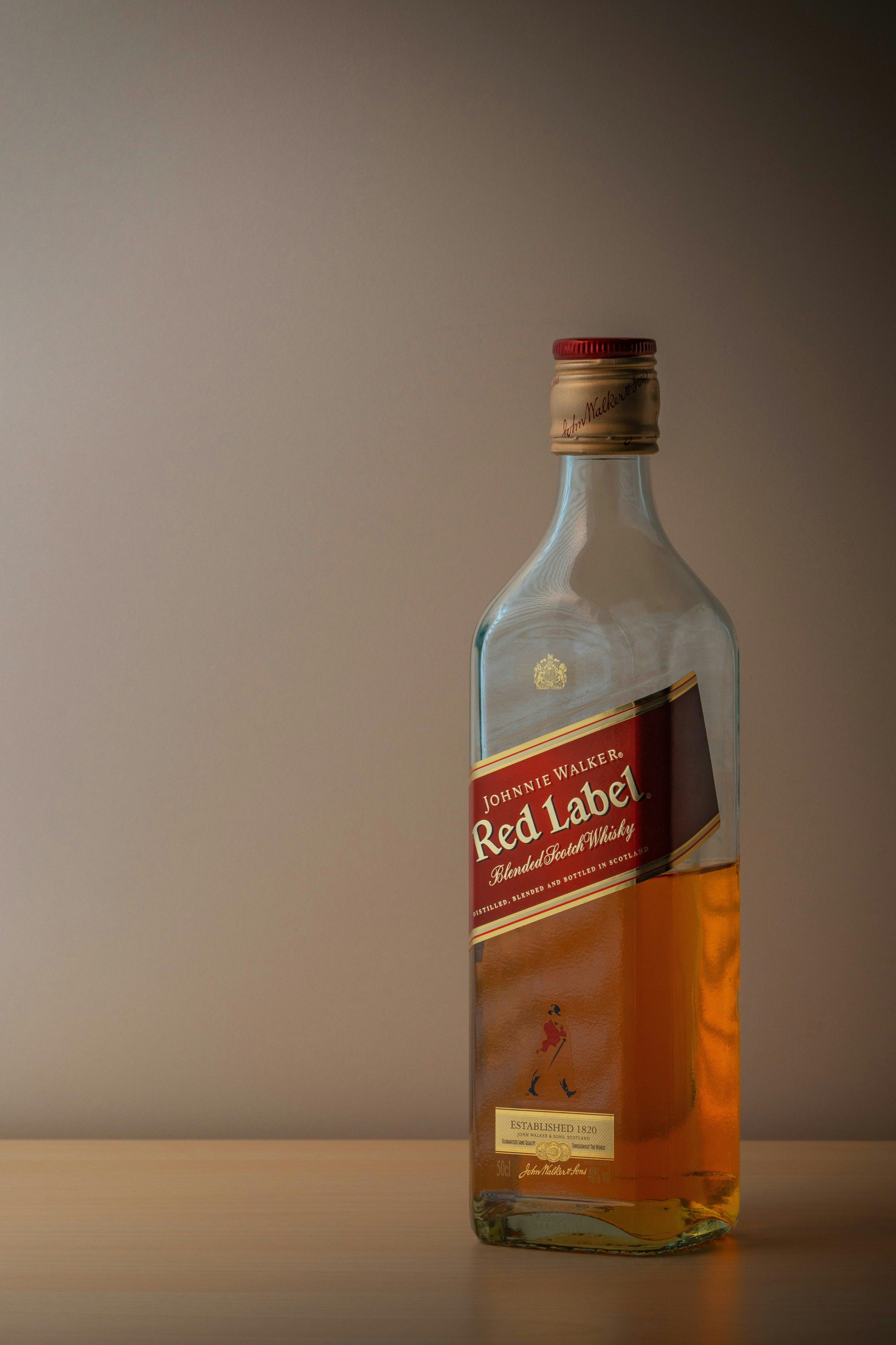 Johnnie walker red label whisky bottle with amber liquid